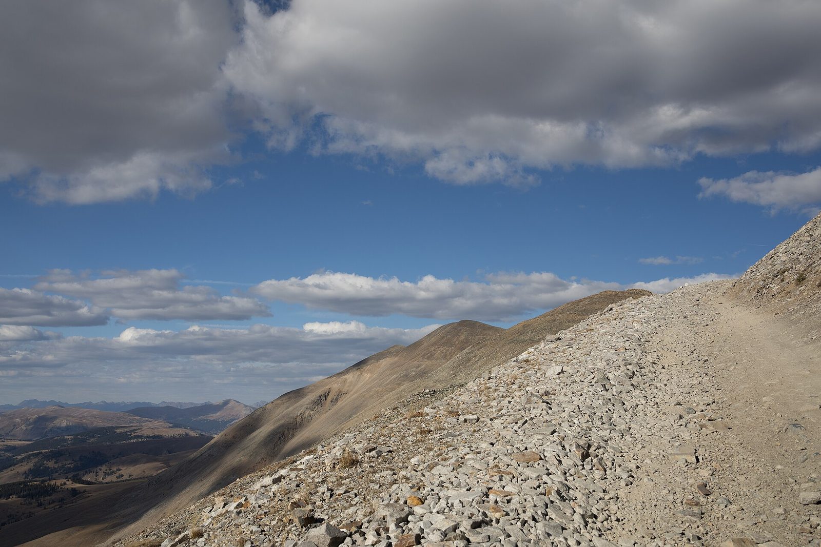 A rocky mountain road climbing above treeline toward the Mosquito Pass summit